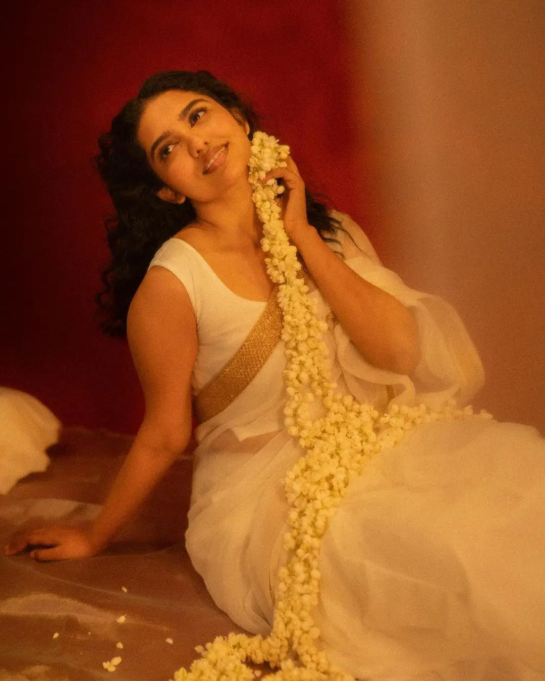 mamitha baiju in white saree sleeveless blouse